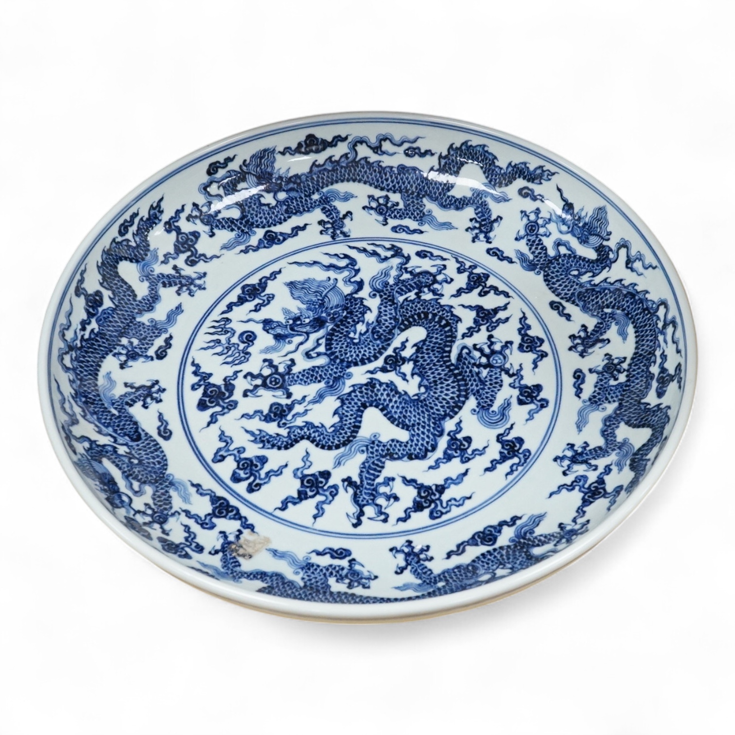A large Chinese blue and white dragon charger, apocryphal Xuande mark, 45cm in diameter